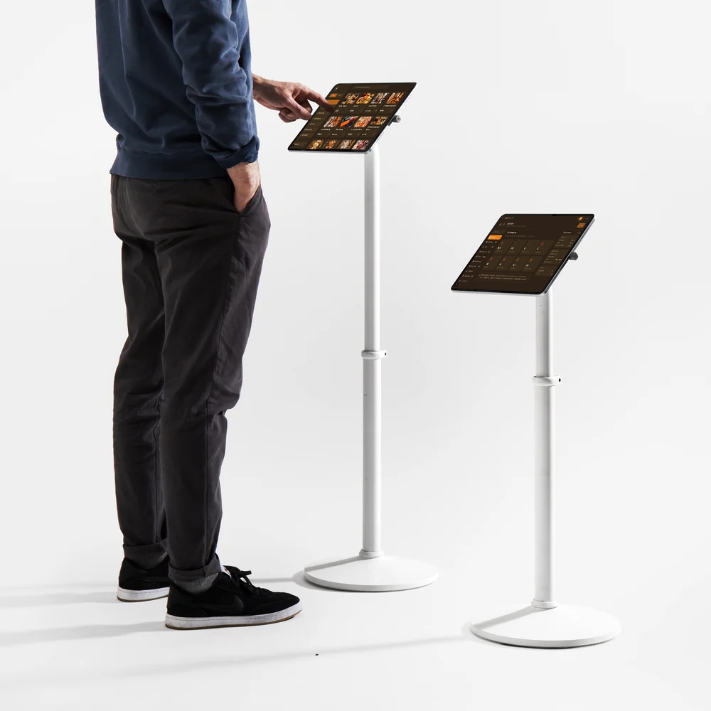 Devotee self-service check-in on Temple Hub floor-standing iPad kiosks